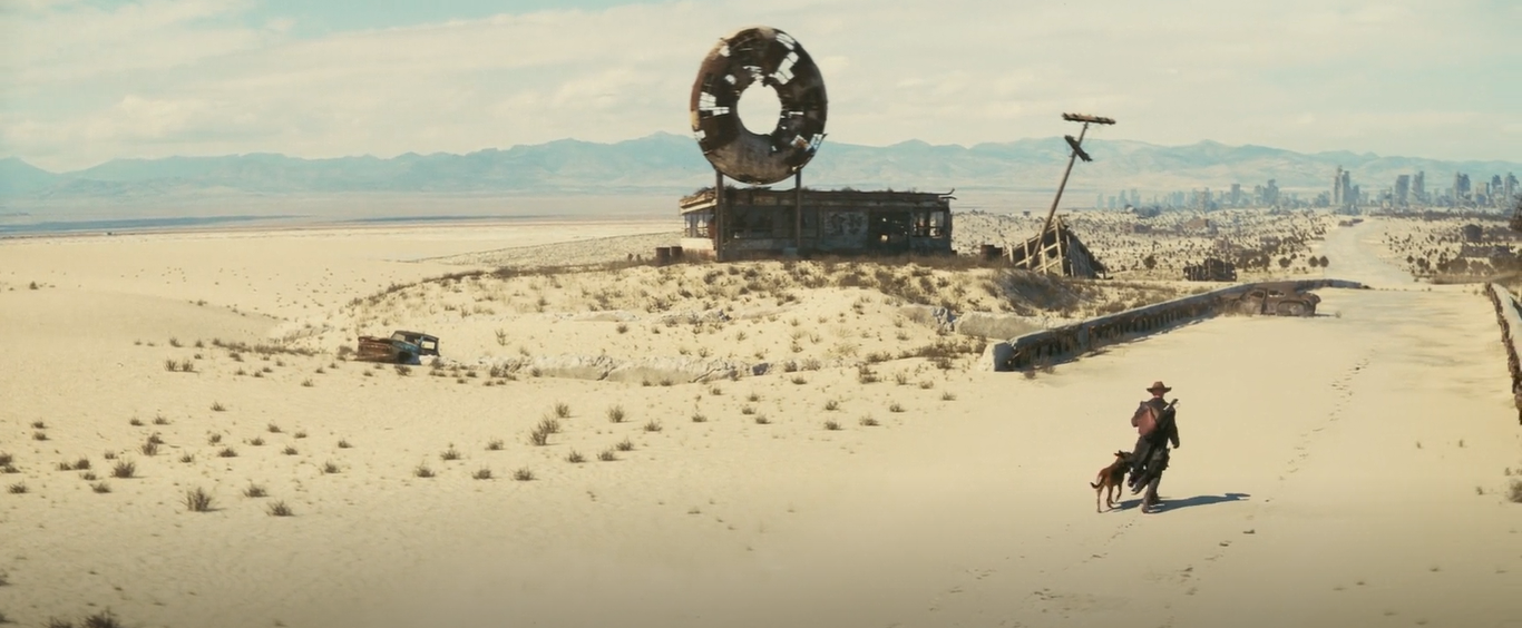 Fallout Character "The Ghoul" walking across a desolate wasteland alongside a dog.