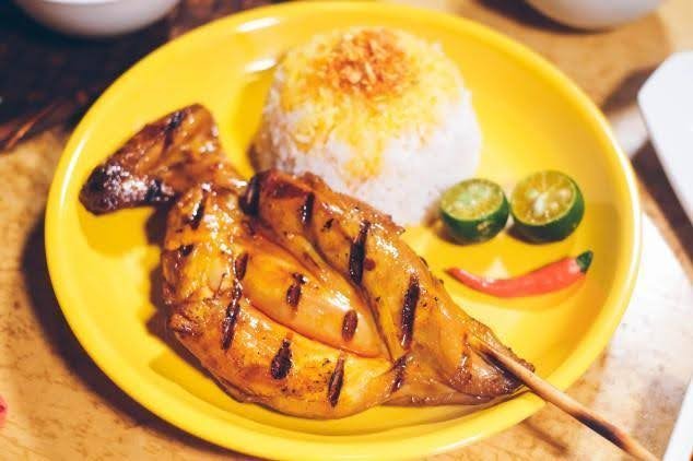 JT’S Manukan Grille’s chicken inasal served with a cup of rice and sides of kalamansi and hot pepper.