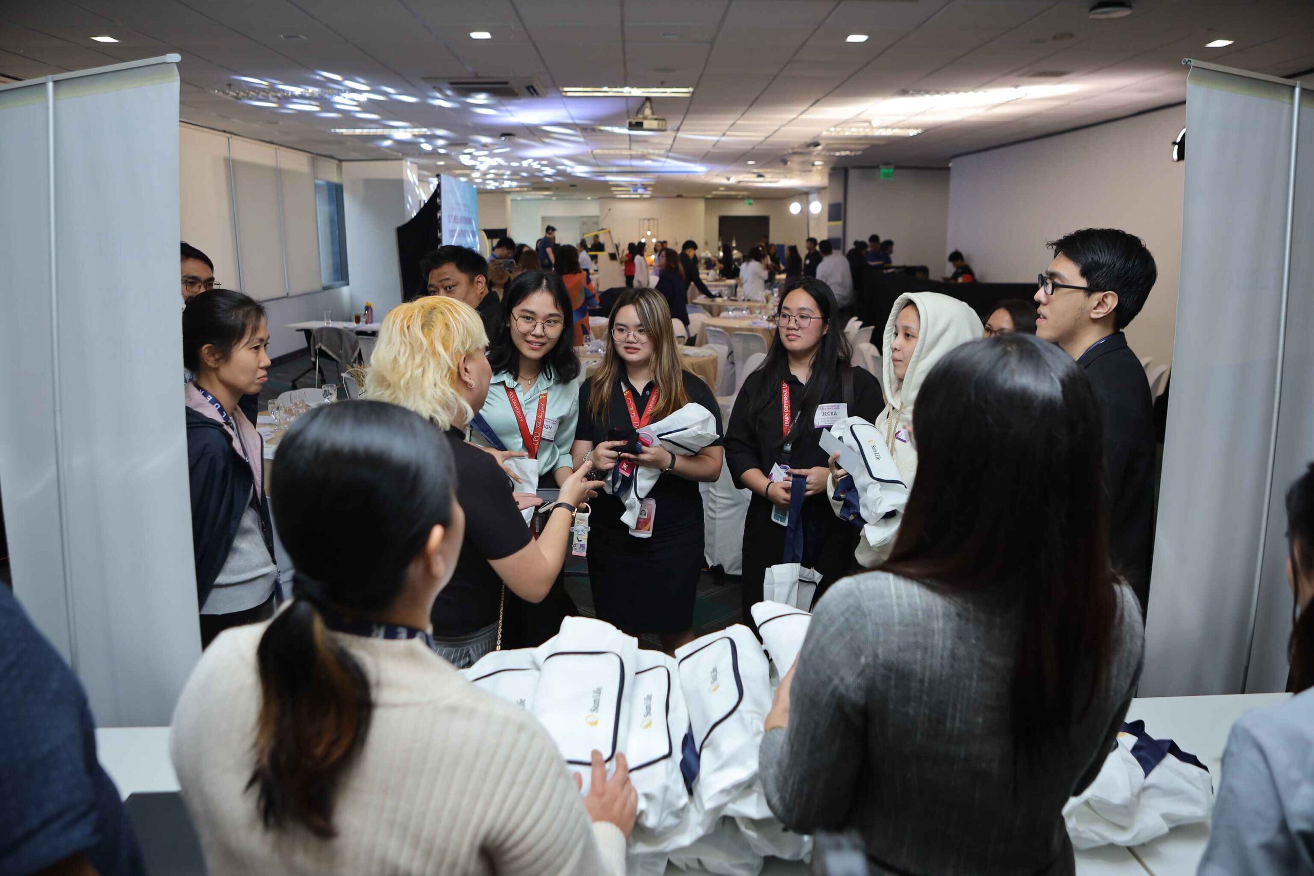 Sun Life Global Solutions Philippines teams eagerly welcome student participants as they go around the booths during the IT Girls Career Workshop, where they answer some of the students’ questions about career in technology.