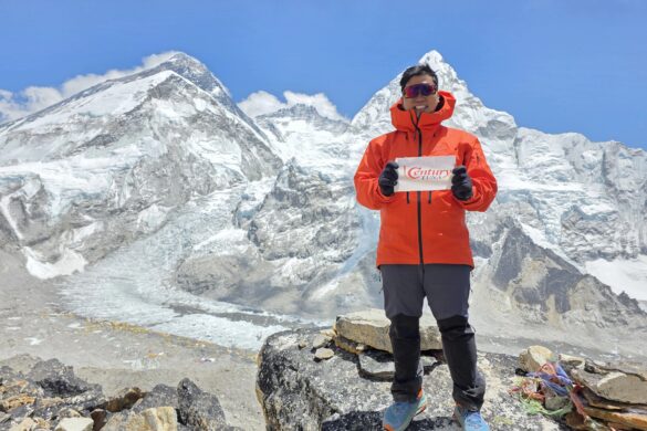 Jeno Panganiban holds up the Century Tuna flag at the Mount Everest Base Camp